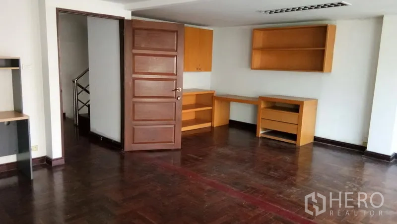 Office Space for rent in Sathon, Bangkok - Private office room with wooden flooring and built-in desks and shelves.