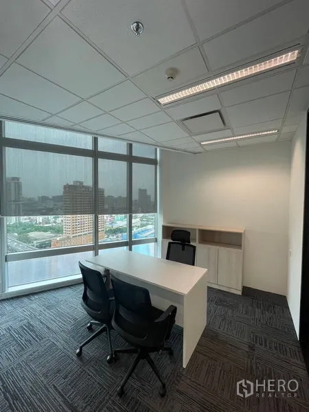 Office Space for rent in Dusit, Bangkok - Private manager’s office with desk, two guest chairs and large windows with city views.
