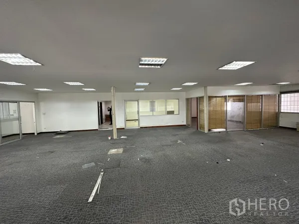 Warehouse for rent in Huai Khwang, Bangkok - Office floor showing meeting rooms with glass walls and blinds.