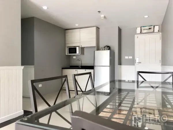 คอนโด ให้เช่าในKhlong Toei, Bangkok - ครัวขนาดกะทัดรัดพร้อมไมโครเวฟ ตู้เก็บของ และตู้เย็นขนาดใหญ่ติดกับโต๊ะอาหาร