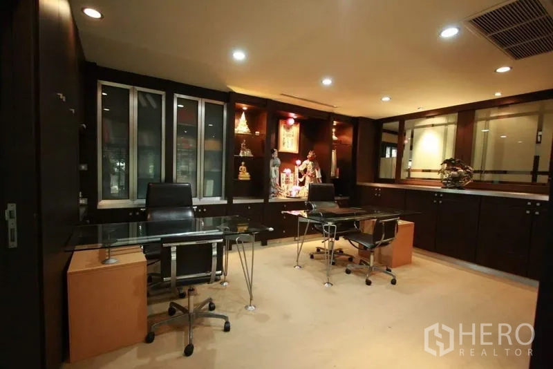 Detached House for rent in Bang Phli, Samut Prakan - Dedicated home office with dark built-in cabinetry, glass desks and recessed lights.