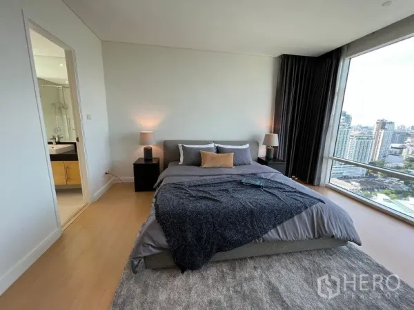 Condominium for rent in Watthana, Bangkok - Spacious master bedroom with skyline views and ensuite entrance.