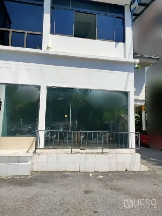 Retail Space for rent in Sathon, Bangkok - Street-level retail unit with wide glass storefront, white facade, metal railing, and small forecourt in Sathon, Bangkok.