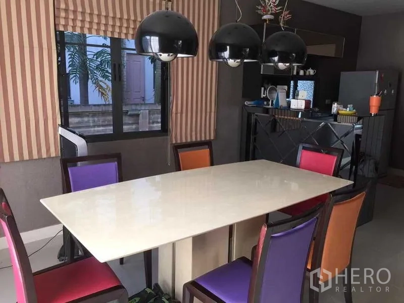 Detached House for sale in Khlong Sam Wa, Bangkok - Dining area with marble-look table and modern black pendant lights.