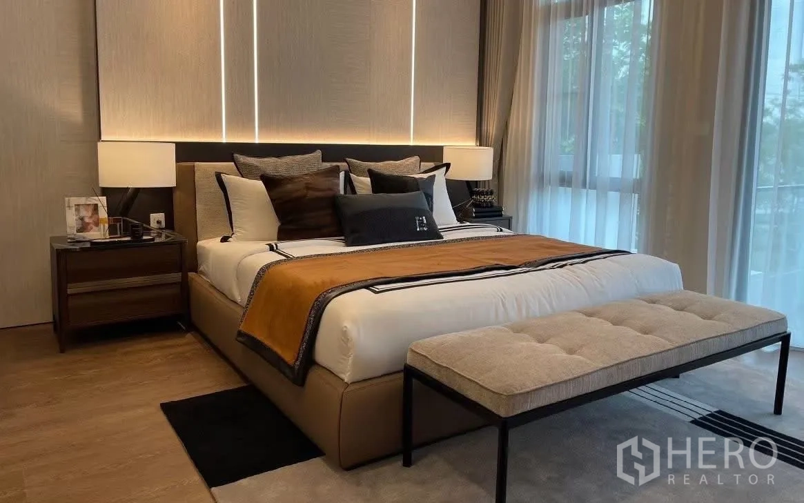 Detached House for rent in Bang Phli, Samut Prakan - Master bedroom with large bed, bench, and floor-to-ceiling curtains.