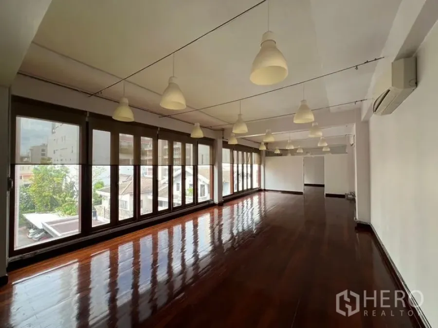 Office Space for rent in Watthana, Bangkok - Long flexible workspace lined with windows, ideal for open-plan desks and collaboration.