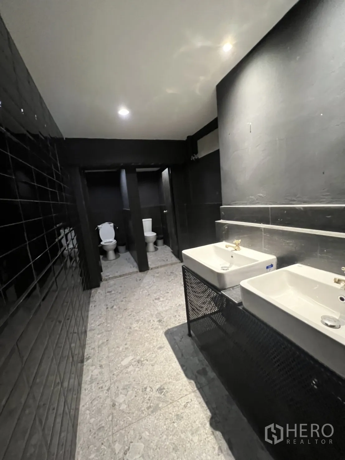 Home Office for rent or sale in Khlong Toei, Bangkok - Large restroom with twin sinks and multiple toilet stalls.