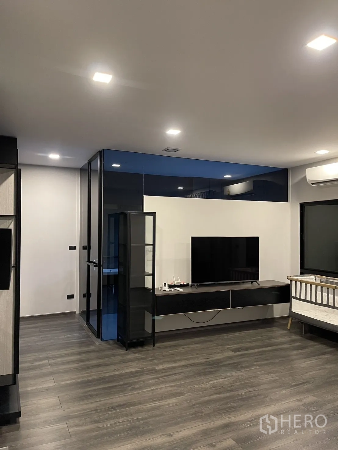 Townhouse for sale in Bang Phli, Samut Prakan - Living area with TV console, glass partition, and recessed ceiling lights.