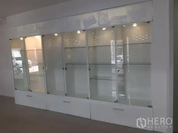 Office Space for rent in Khlong Toei, Bangkok - Built-in illuminated glass display cabinets with sliding doors.