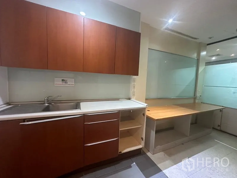 Office Space for rent in Khlong Toei, Bangkok - Pantry with sink, wooden cabinets and work counter in Bangkok office.