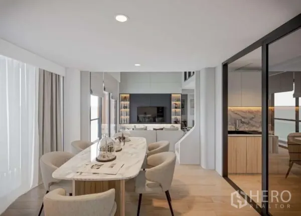 Condominium for rent in Huai Khwang, Bangkok - Dining area with long marble table, six chairs and glass partition to the kitchen.