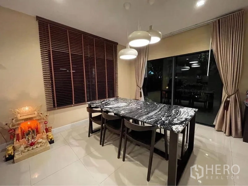 Detached House for rent or sale in Bang Phli, Samut Prakan - Dining area with a black marble table, pendant lights and large windows.
