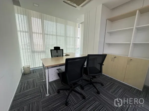 Office Space for rent - Private executive office with desk, ergonomic chairs, and built-in shelving.