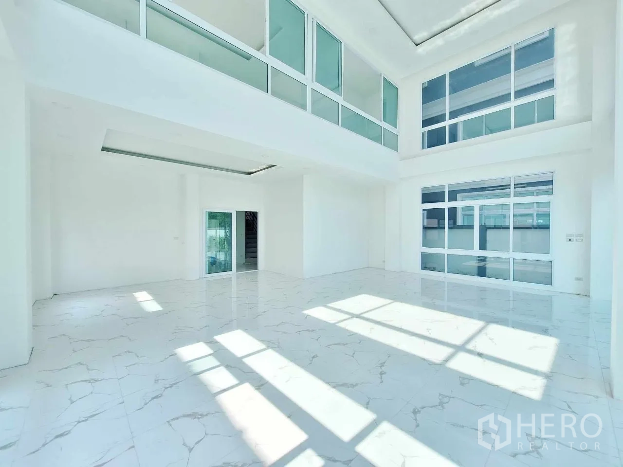 Office Space for sale in Bueng Kum, Bangkok - Sunlit open lobby area with glossy marble floors and large windows.