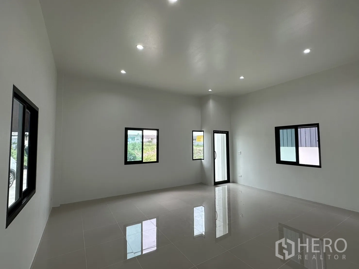 Warehouse for rent or sale - Bright ground‑floor office with tiled floors, multiple windows and downlights.