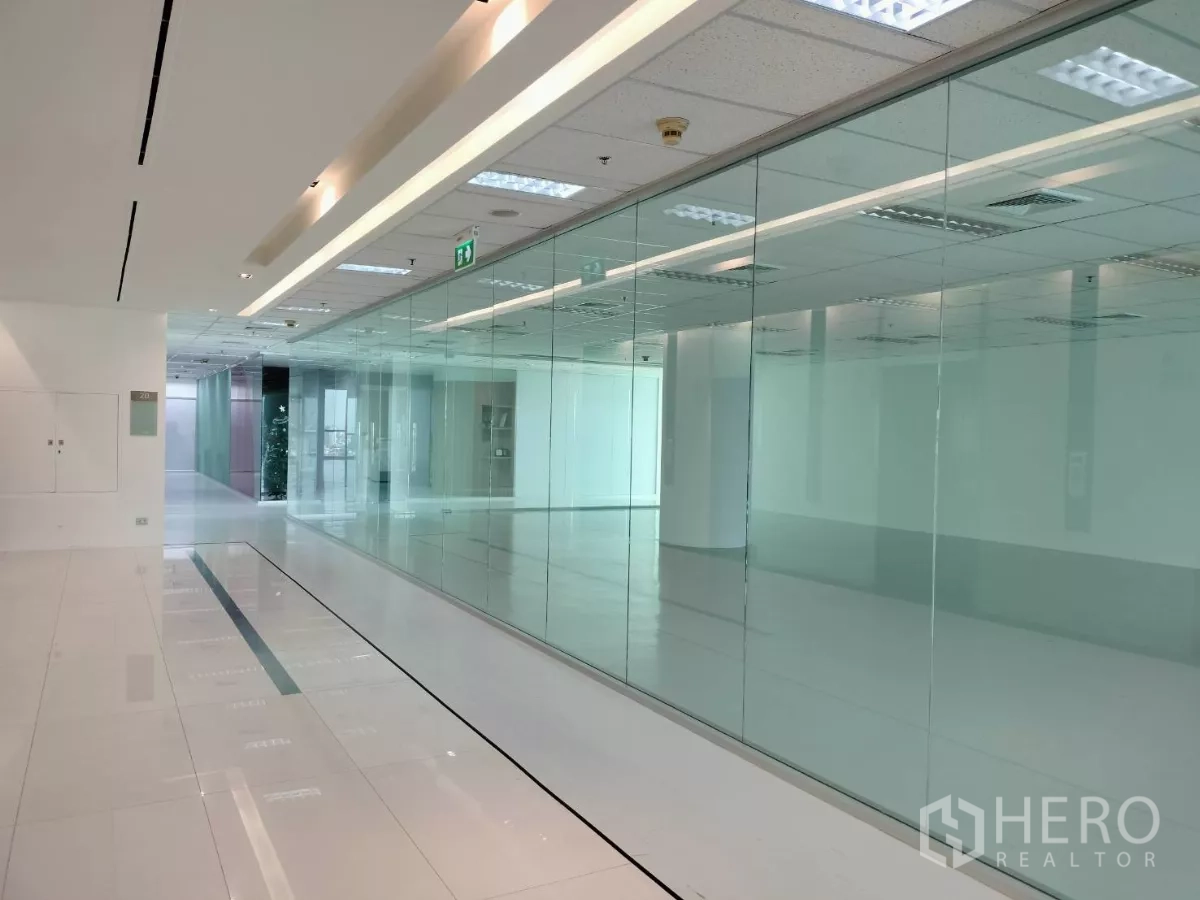 Office Space for rent in Sathon, Bangkok - Bright high-floor office corridor with glass partitions, white tile flooring and recessed lighting in a Sathon CBD building near BTS Saint Louis.
