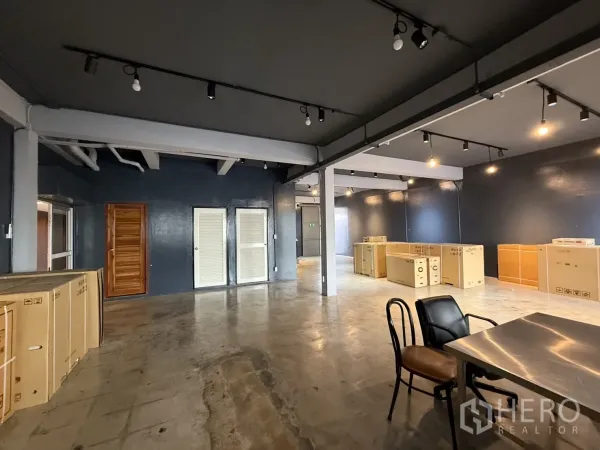 Office Space for rent in Wang Thonglang, Bangkok - Spacious open-plan ground floor with polished concrete, dark ceilings and track lighting.