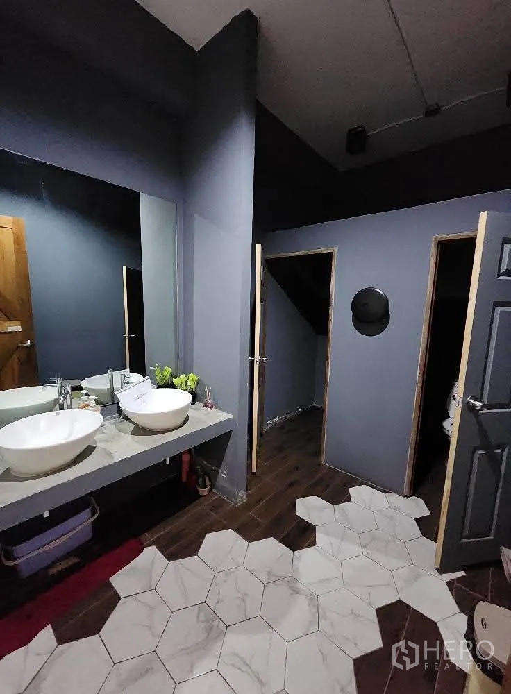 Home Office for rent in Mueang Nonthaburi, Nonthaburi - Restroom with vessel sinks, dark walls and hexagon tile floor.