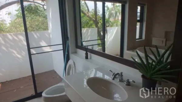 บ้าน ให้เช่าในWatthana, Bangkok - เคาน์เตอร์อ่างล้างหน้ากระจกบานใหญ่ ประตูกระจกเลื่อนสู่ระเบียงวิวต้นไม้