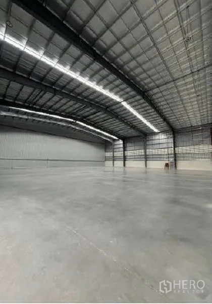 货栈 出租在Mueang Rayong, Rayong - 无柱大型仓储空间，金属墙板与明亮的LED灯带。