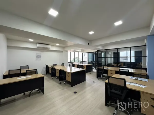 Office Space for rent in Watthana, Bangkok - Bright coworking-style workspace with multiple desks, air-conditioning and black-framed glass partitions.