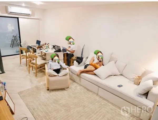 Townhouse for rent in Bang Kapi, Bangkok - Bright open-plan living and dining area with a long sofa, dining table, and sliding glass door.