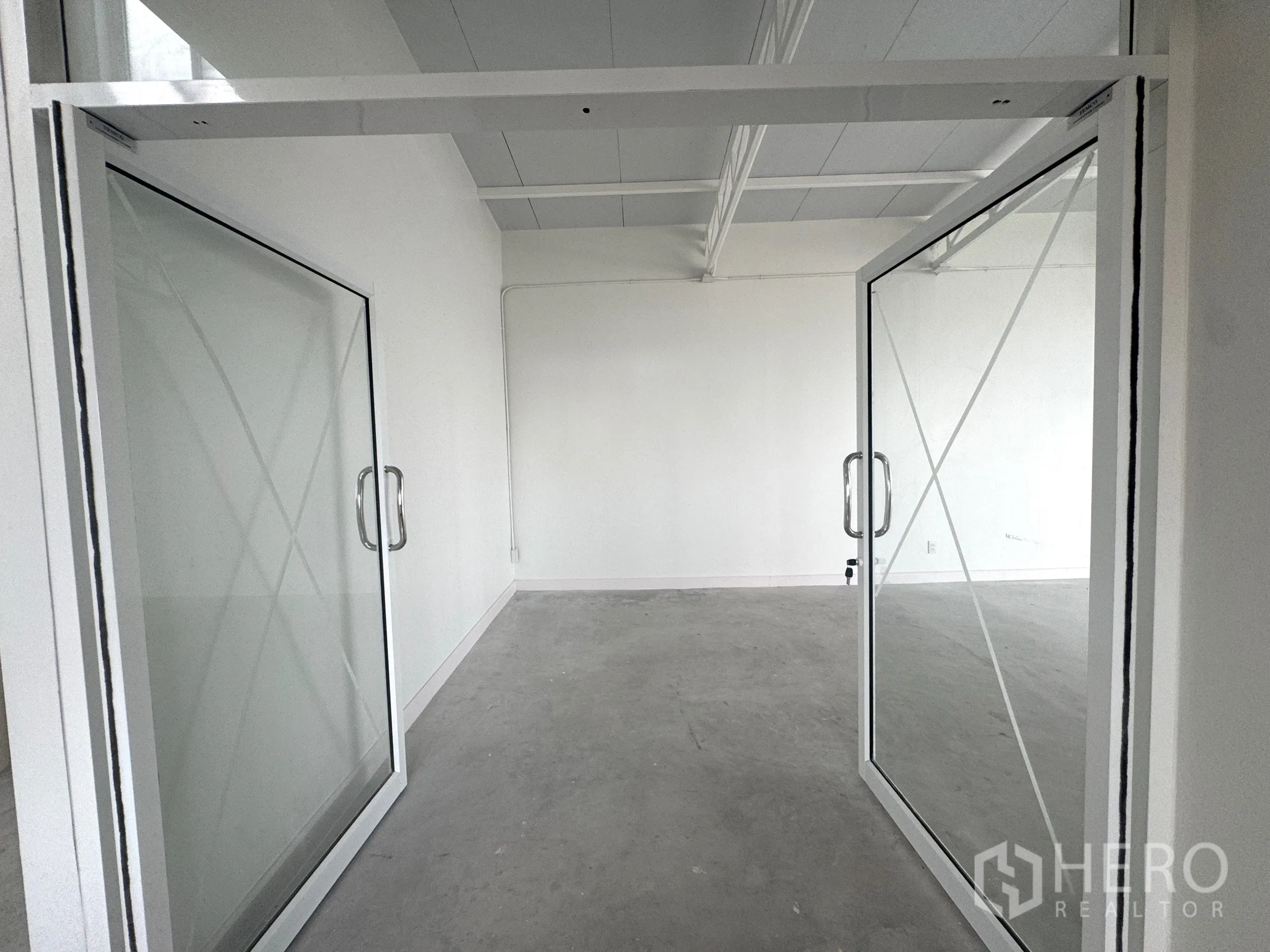 办公室 for rent in Sathon, Bangkok - 双扇玻璃门入口通向整洁的开放式办公区。