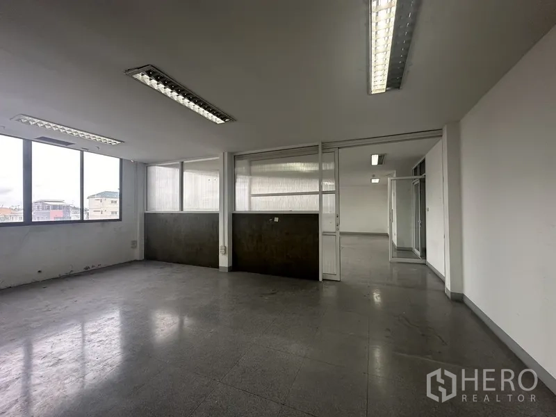 Office Space for rent in Khlong Toei, Bangkok - Private office with large windows, partition walls and overhead lighting.