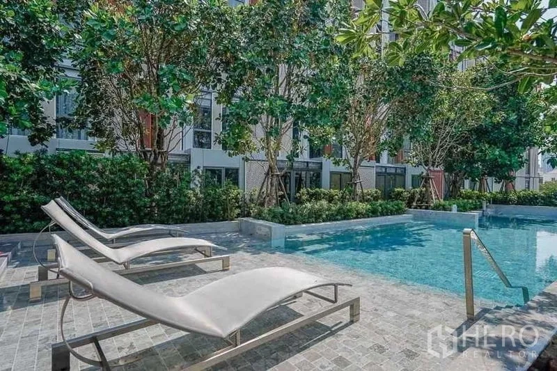 คอนโด ให้เช่าในWatthana, Bangkok - สระว่ายน้ำของคอนโด พร้อมเตียงอาบแดด และต้นไม้ร่มรื่น