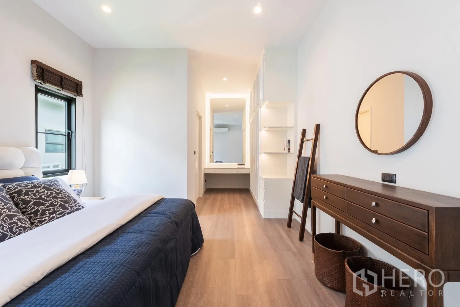 Detached House for rent or sale in Bang Phli, Samut Prakan - Spacious bedroom view toward a lit vanity area and built-in storage.