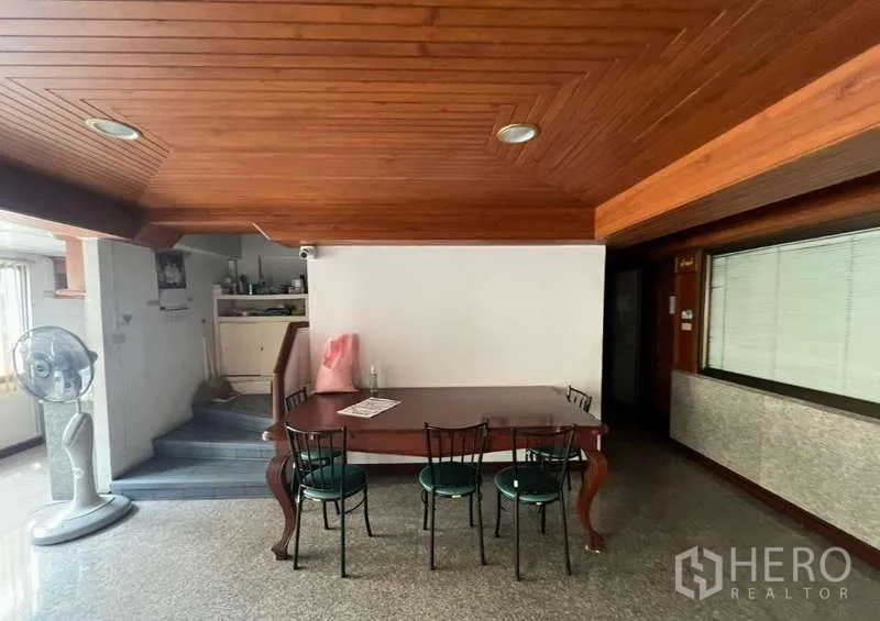 Office Space for rent - Meeting or pantry area with wooden ceiling and dining table.