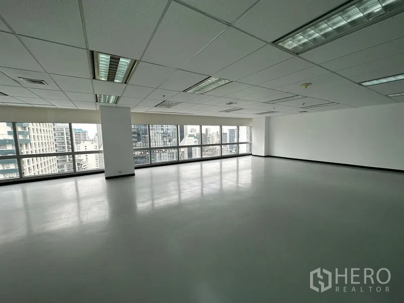 Office Space for rent - Open-plan office floor with full-length windows and Bangkok skyline views.
