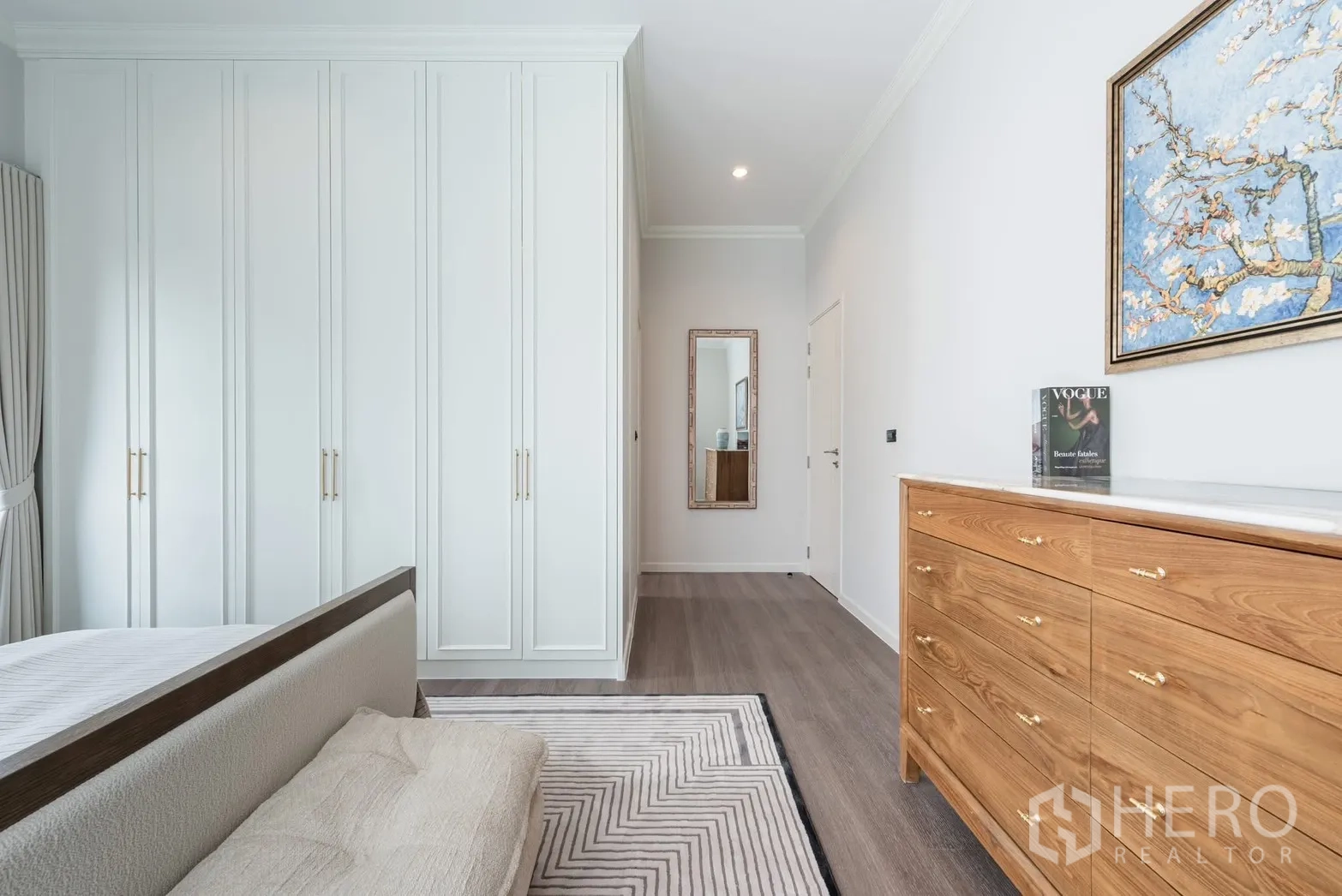 Detached House for rent or sale in Bang Phli, Samut Prakan - Bedroom corner showcasing tall built-in white wardrobes and wooden dresser.