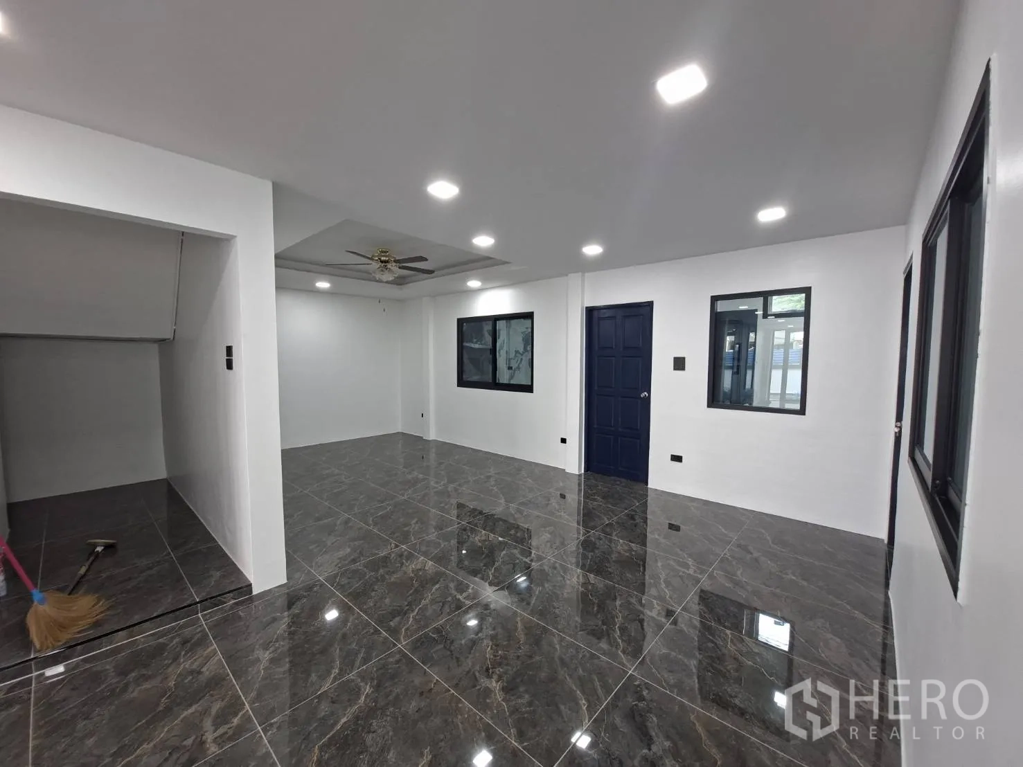家庭办公室 for rent in Phra Khanong, Bangkok - 房间内有吊扇、仿大理石地砖和多扇窗户。