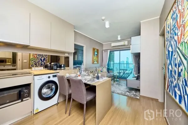 Condominium for rent in Phra Khanong, Bangkok - Open-plan kitchen and dining leading to a living room with balcony and sweeping city views.