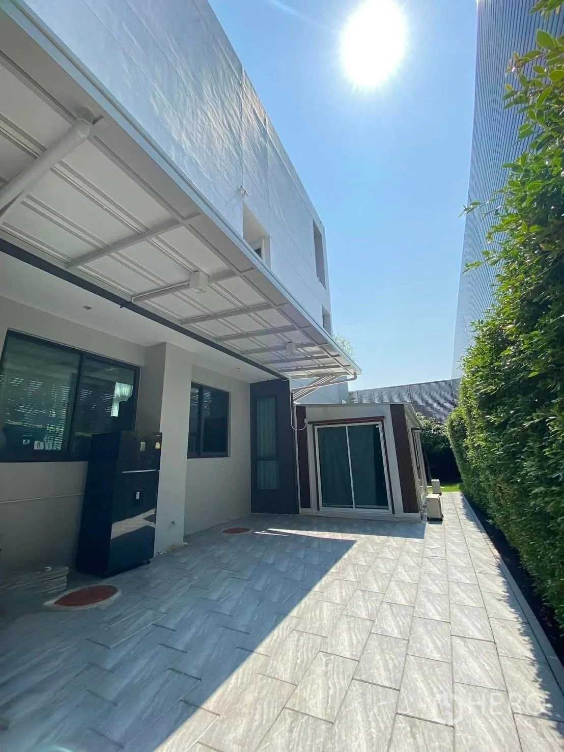 Detached House for rent or sale in Suan Luang, Bangkok - Tiled side terrace beside the house with awning and sliding door.