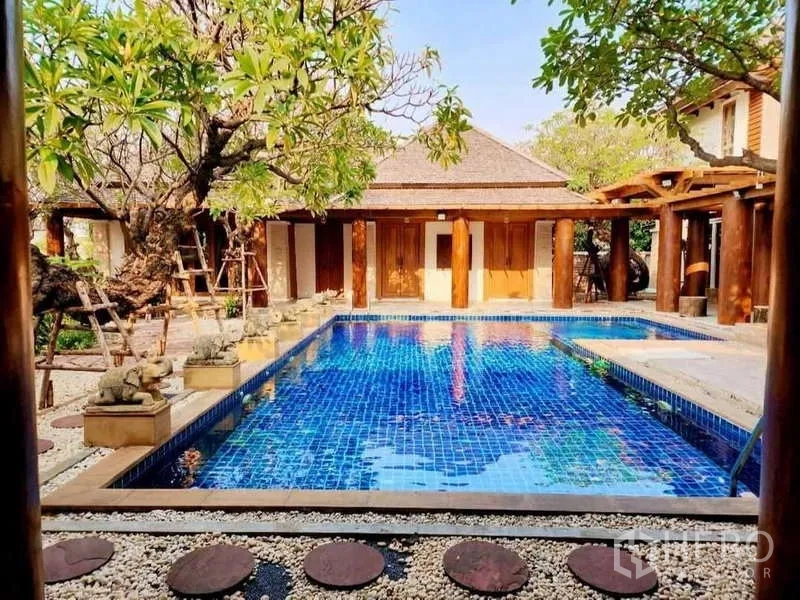 Detached House for sale in Bueng Kum, Bangkok - Daytime view of private pool with stepping stones and pavilion backdrop.