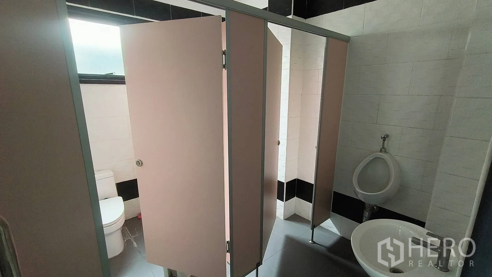 Office Space for rent in Khlong Toei, Bangkok - Men’s restroom with urinal, stalls and sink.