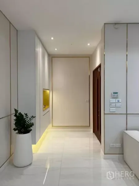 独立式住宅 出租在Phaya Thai, Bangkok - 明亮走廊，白色大理石地面与嵌灯，内置装饰格。