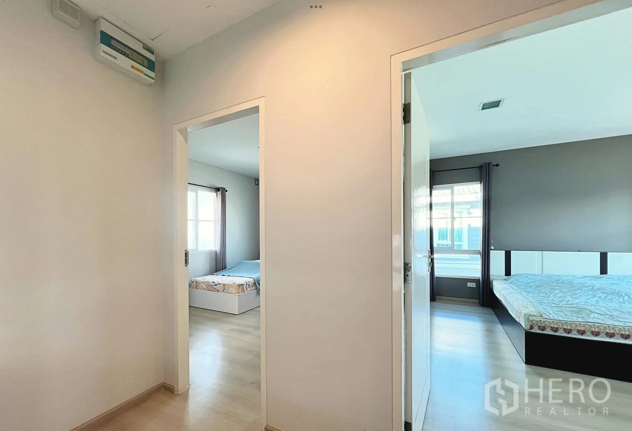 Townhouse for rent or sale in Sai Mai, Bangkok - Upper landing leading to two bedrooms with light wood floors.