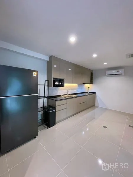 Townhouse for rent in Bang Phli, Samut Prakan - Alternative view of fitted kitchen with hob, sink and ample storage.