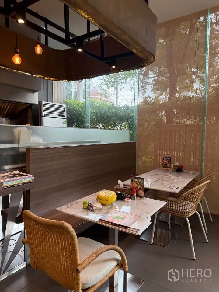 Retail Space for rent in Watthana, Bangkok - Booth seating with marble tables under feature lighting by a window.
