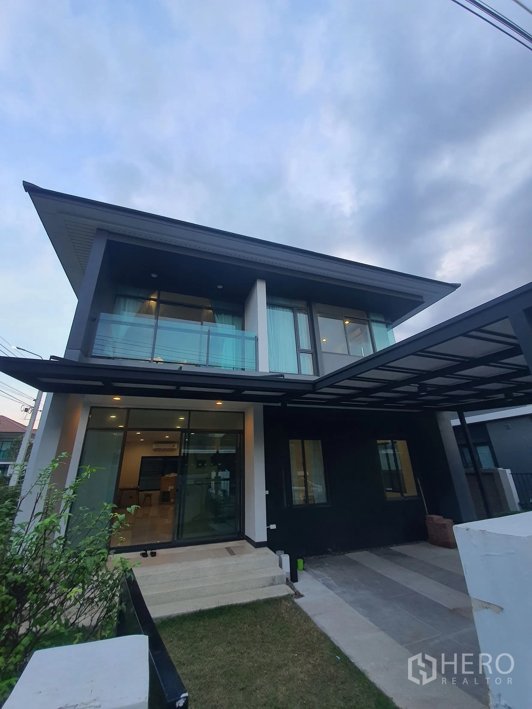 บ้าน ให้เช่าในBang Kapi, Bangkok - มุมมองภายนอก แสดงระเบียงกระจก ประตูบานเลื่อน และที่จอดรถมีหลังคา