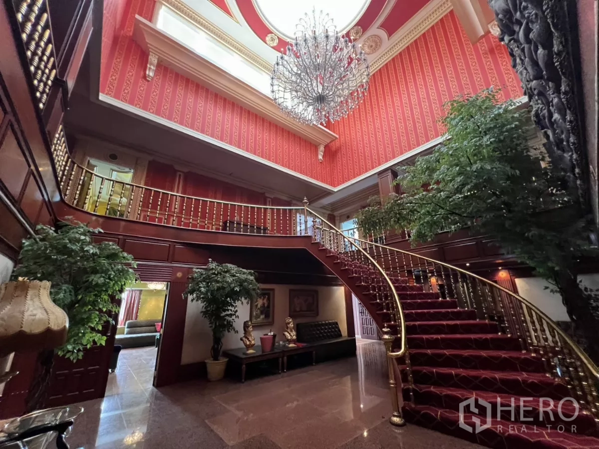 Retail Space for rent in Watthana, Bangkok - Grand foyer with sweeping red-carpet staircase and crystal chandelier.