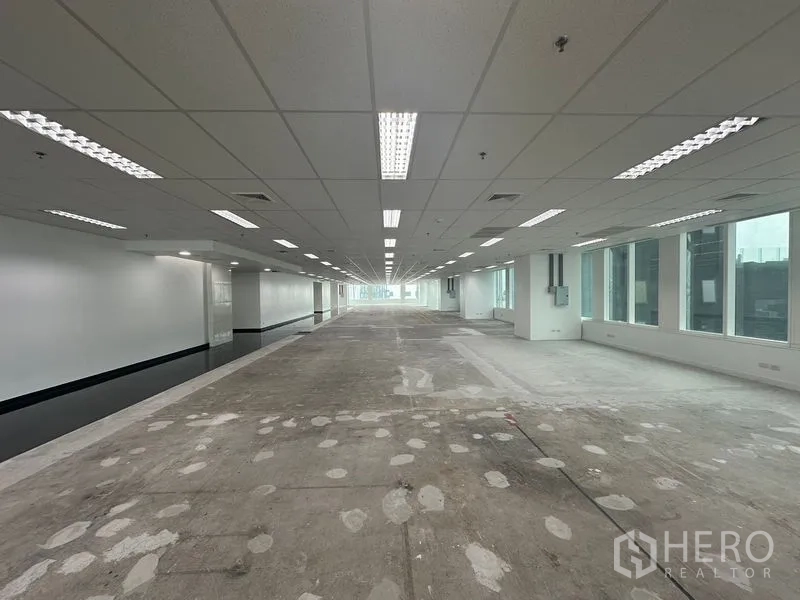 Office Space for rent - Corner of the office floor with angled windows and a skyline backdrop.