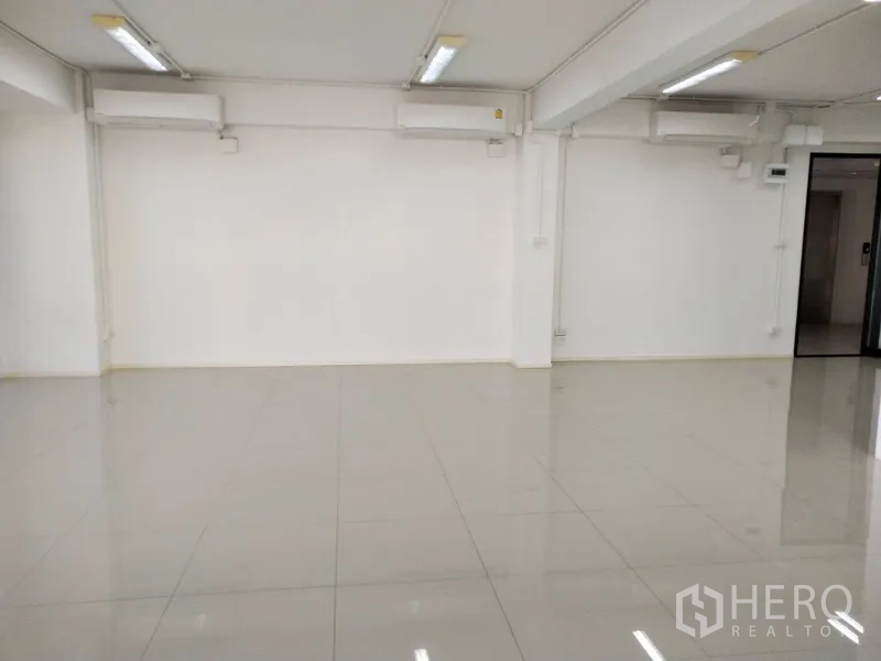 Office Space for rent in Bang Na, Bangkok - Air-conditioned office interior with linear ceiling lights and polished floors.