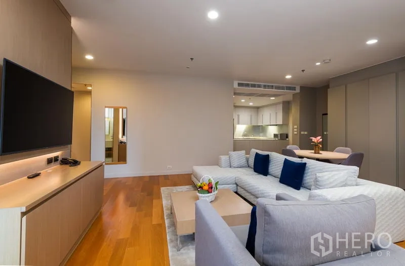Condominium for rent in Bang Kho Laem, Bangkok - Large lounge with TV console, sofa set and open-plan layout toward the kitchen.