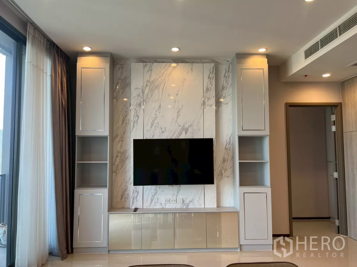 Condominium for rent in Phra Khanong, Bangkok - Close-up of marble TV wall unit with storage in the living room.
