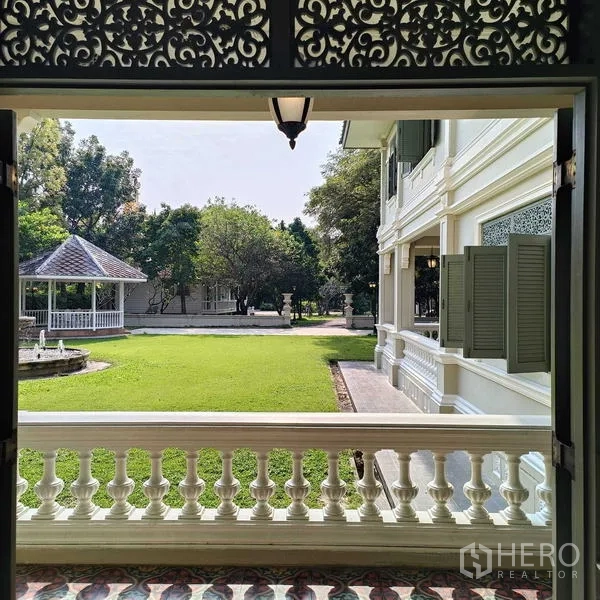 Detached House for rent or sale in Krathum Baen, Samut Sakhon - Covered terrace facing green lawn with fountain and a garden gazebo.