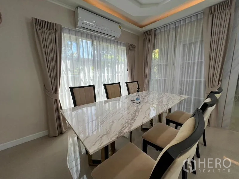 Detached House for rent or sale - Dining zone with marble-top table surrounded by windows.